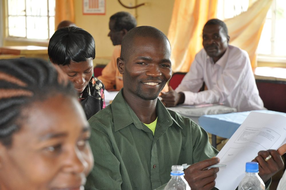 Community health workers in a training session taking notes